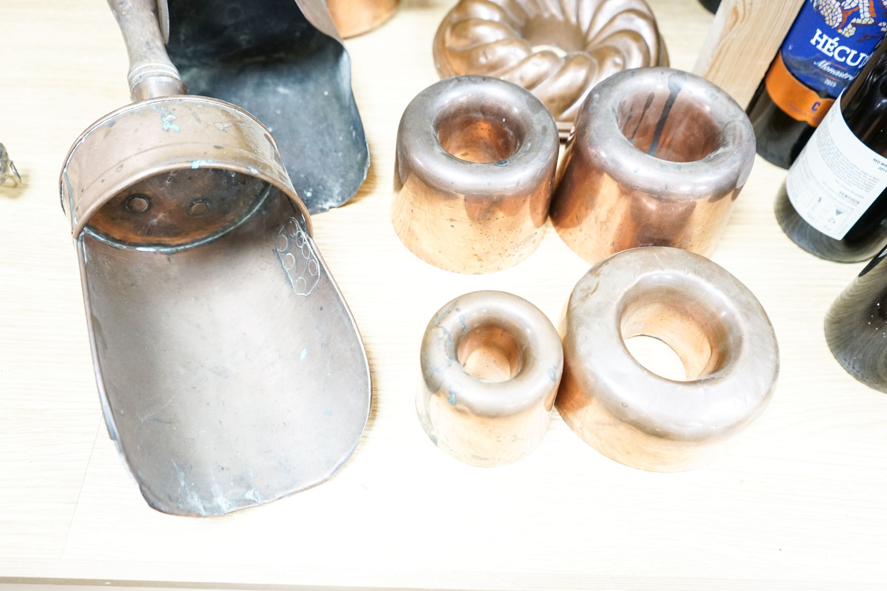 A mixed group of copper wares including Victorian jelly moulds, coal scoops, vase etc